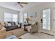 Cozy living room features a comfortable sofa, wicker chair, and natural light from the windows at 216 Kirkland Dr, New Smyrna Beach, FL 32169