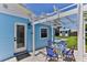 Outdoor patio area features a white pergola, table with seating, and backyard views at 216 Kirkland Dr, New Smyrna Beach, FL 32169