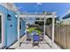 Charming patio with a pergola, outdoor seating, and a well-maintained yard at 216 Kirkland Dr, New Smyrna Beach, FL 32169