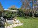 Inviting backyard with covered patio and well-manicured lawn at 2321 Tamarind Dr, Edgewater, FL 32141