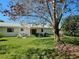 Expansive backyard with mature tree and white exterior at 2321 Tamarind Dr, Edgewater, FL 32141