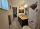 Bright bathroom featuring a vanity, mirror, and a view into the bedroom, and decorative accents at 2321 Tamarind Dr, Edgewater, FL 32141