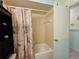 Bathroom featuring a shower-tub combination, floral shower curtain, and a compact design at 2321 Tamarind Dr, Edgewater, FL 32141
