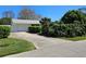 Beautiful single-story home with a well-maintained front yard, garage, and lush greenery at 2321 Tamarind Dr, Edgewater, FL 32141