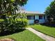 Well-manicured lawn and a tidy landscape add curb appeal to this charming home at 2321 Tamarind Dr, Edgewater, FL 32141