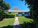 Inviting single-story home with a neat walkway and lush greenery enhancing its appeal at 2321 Tamarind Dr, Edgewater, FL 32141