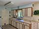 Bright eat-in kitchen features updated cabinets and countertops with open view to the yard at 2321 Tamarind Dr, Edgewater, FL 32141