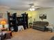 Comfortable living room featuring neutral carpet, fan, and built-in shelving at 2321 Tamarind Dr, Edgewater, FL 32141