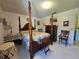 Spacious bedroom featuring a four-poster bed, dresser, and neutral-toned walls and carpet at 2321 Tamarind Dr, Edgewater, FL 32141