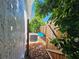 Exterior side yard featuring an AC unit, wooden fence, and some greenery at 2321 Tamarind Dr, Edgewater, FL 32141