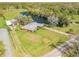 Aerial view of a home features a pond, barns, sprawling yard, and lush landscaping, offering a private retreat at 2533 Glenhaven St, New Smyrna Beach, FL 32168