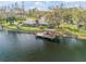 Aerial view of a waterfront property with a cozy home and a private dock at 2533 Glenhaven St, New Smyrna Beach, FL 32168