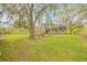 Expansive backyard features a barn and beautiful trees, creating a peaceful and rustic setting at 2533 Glenhaven St, New Smyrna Beach, FL 32168