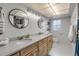 Bright bathroom features double vanity, granite counters, and modern lighting fixtures at 2533 Glenhaven St, New Smyrna Beach, FL 32168