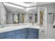 Bright bathroom boasts custom blue cabinets, spacious countertop, and decorative shelving at 2533 Glenhaven St, New Smyrna Beach, FL 32168