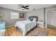 Cozy bedroom with wood floors, ceiling fan, and colorful accent rug at 2533 Glenhaven St, New Smyrna Beach, FL 32168