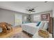 Bright bedroom with warm wood floors, large windows, and stylish furnishings at 2533 Glenhaven St, New Smyrna Beach, FL 32168