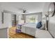 Bright bedroom featuring a ceiling fan, built-in shelving, and large window for ample natural light at 2533 Glenhaven St, New Smyrna Beach, FL 32168