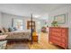 Bedroom with a four-poster bed, a decorative fireplace, a dresser, and natural light at 2533 Glenhaven St, New Smyrna Beach, FL 32168