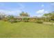 Charming brick home featuring a manicured lawn and colorful landscaping at 2533 Glenhaven St, New Smyrna Beach, FL 32168