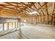 Open loft area features wood floors, exposed beams, basketball hoop, and ample space for activities or storage at 2533 Glenhaven St, New Smyrna Beach, FL 32168