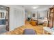 Bright main bedroom features a four-poster bed, wood floors, and an ensuite bathroom with modern updates at 2533 Glenhaven St, New Smyrna Beach, FL 32168