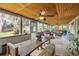 Expansive screened porch with ceiling fan, ample seating, and beautiful views of the pond and surrounding landscape at 2533 Glenhaven St, New Smyrna Beach, FL 32168