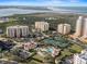 Aerial shot of condo community near the inlet, highlighting a pool, tennis courts, and beautiful coastal scenery at 261 Minorca Beach Way # 606, New Smyrna Beach, FL 32169