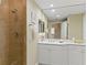Bathroom featuring a tiled shower and a white vanity with an ample countertop at 261 Minorca Beach Way # 606, New Smyrna Beach, FL 32169