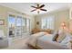 Inviting bedroom featuring shuttered windows, sliding glass doors, and neutral decor at 261 Minorca Beach Way # 606, New Smyrna Beach, FL 32169
