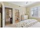 Bedroom with an ensuite bathroom, a ceiling fan, and shuttered windows at 261 Minorca Beach Way # 606, New Smyrna Beach, FL 32169