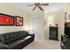 Bedroom with a leather couch, ceiling fan, and ample decorations at 261 Minorca Beach Way # 606, New Smyrna Beach, FL 32169