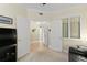 Inviting entryway with neutral walls, arched doorway, and white shuttered windows, offering a glimpse into the main hall at 261 Minorca Beach Way # 606, New Smyrna Beach, FL 32169