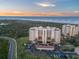 A scenic exterior shot of the condo complex, showcasing its prime location near the beach at sunset at 261 Minorca Beach Way # 606, New Smyrna Beach, FL 32169