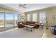 Spacious living area featuring a corner sofa, balcony access, and picturesque ocean views at 261 Minorca Beach Way # 606, New Smyrna Beach, FL 32169