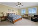 The bedroom has a ceiling fan and windows that provide a scenic view at 261 Minorca Beach Way # 606, New Smyrna Beach, FL 32169
