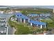 Aerial view of waterfront condos with blue roofs, marina, and ocean view in Ponce Inlet at 2700 N Peninsula Ave # 113, New Smyrna Beach, FL 32169