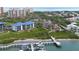 Aerial view of condos, a dock for boating, and the lush greenery and ocean in the distance at 2700 N Peninsula Ave # 113, New Smyrna Beach, FL 32169