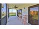 Relax on this screened balcony with a ceiling fan, comfortable seating, and panoramic views of the marina at 2700 N Peninsula Ave # 113, New Smyrna Beach, FL 32169