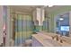 Bathroom with a sink, mirror, toilet, and shower with a striped curtain at 2700 N Peninsula Ave # 113, New Smyrna Beach, FL 32169