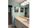Fresh bathroom vanity with a spacious countertop, a large mirror, and a shower with glass doors at 2700 N Peninsula Ave # 113, New Smyrna Beach, FL 32169