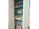 Well-organized bathroom linen closet with neatly stacked towels on shelves with space for storage at 2700 N Peninsula Ave # 113, New Smyrna Beach, FL 32169