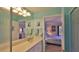 A well-lit bathroom connects to the bedroom, featuring a single sink vanity and a walk-in shower at 2700 N Peninsula Ave # 113, New Smyrna Beach, FL 32169