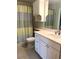 Bathroom featuring a white vanity with drawers, a sink, mirror, and a coordinated shower curtain at 2700 N Peninsula Ave # 113, New Smyrna Beach, FL 32169
