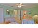 Serene bedroom with twin beds and connected bathroom, offering a tranquil and convenient layout at 2700 N Peninsula Ave # 113, New Smyrna Beach, FL 32169
