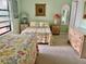 Charming bedroom with two cozy beds, matching bedside tables, and soft lighting throughout the space at 2700 N Peninsula Ave # 113, New Smyrna Beach, FL 32169