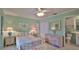 Cozy bedroom with a calming color scheme, featuring a ceiling fan and ensuite bathroom at 2700 N Peninsula Ave # 113, New Smyrna Beach, FL 32169