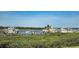 The waterfront scene reveals a view of docked boats amidst serene waters on a sunny day at 2700 N Peninsula Ave # 113, New Smyrna Beach, FL 32169