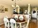 Dining area with wood table, wicker chairs, and kitchen view at 2700 N Peninsula Ave # 113, New Smyrna Beach, FL 32169