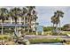 Signage for Inlet Marina Villas featuring lush landscaping, a statue, and a view of the complex at 2700 N Peninsula Ave # 113, New Smyrna Beach, FL 32169